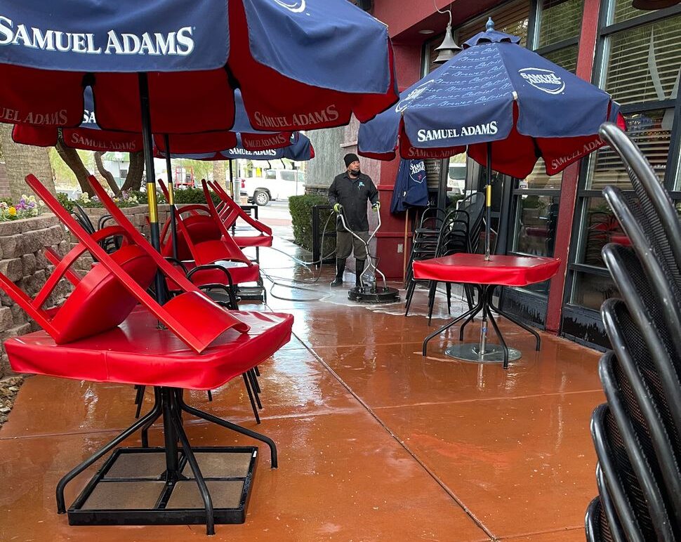 a red tables and chairs under umbrellas