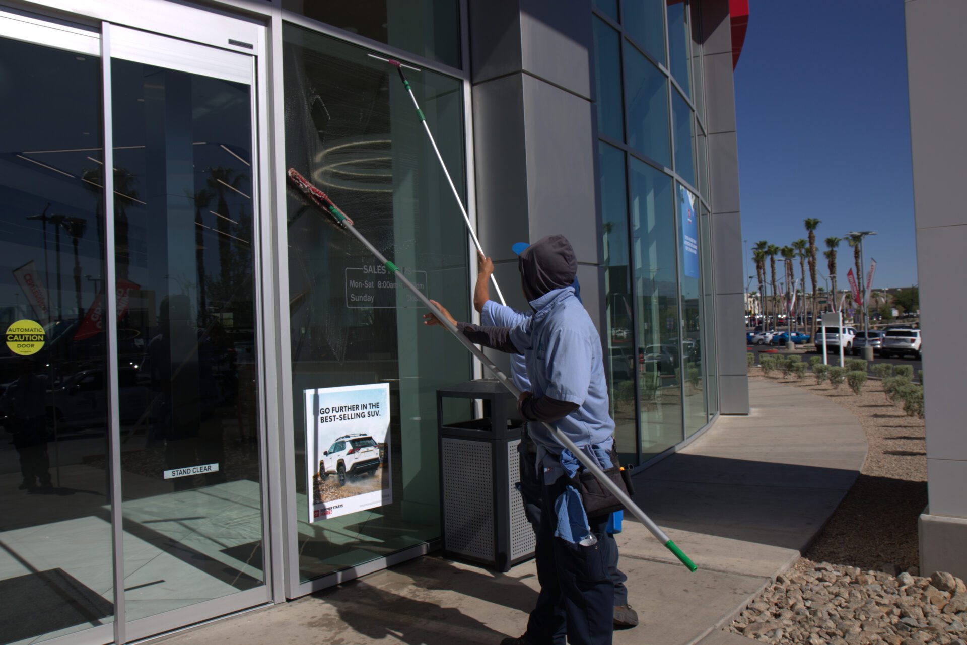 A man diligently cleans a glass door, ensuring it is spotless and clear for better visibility