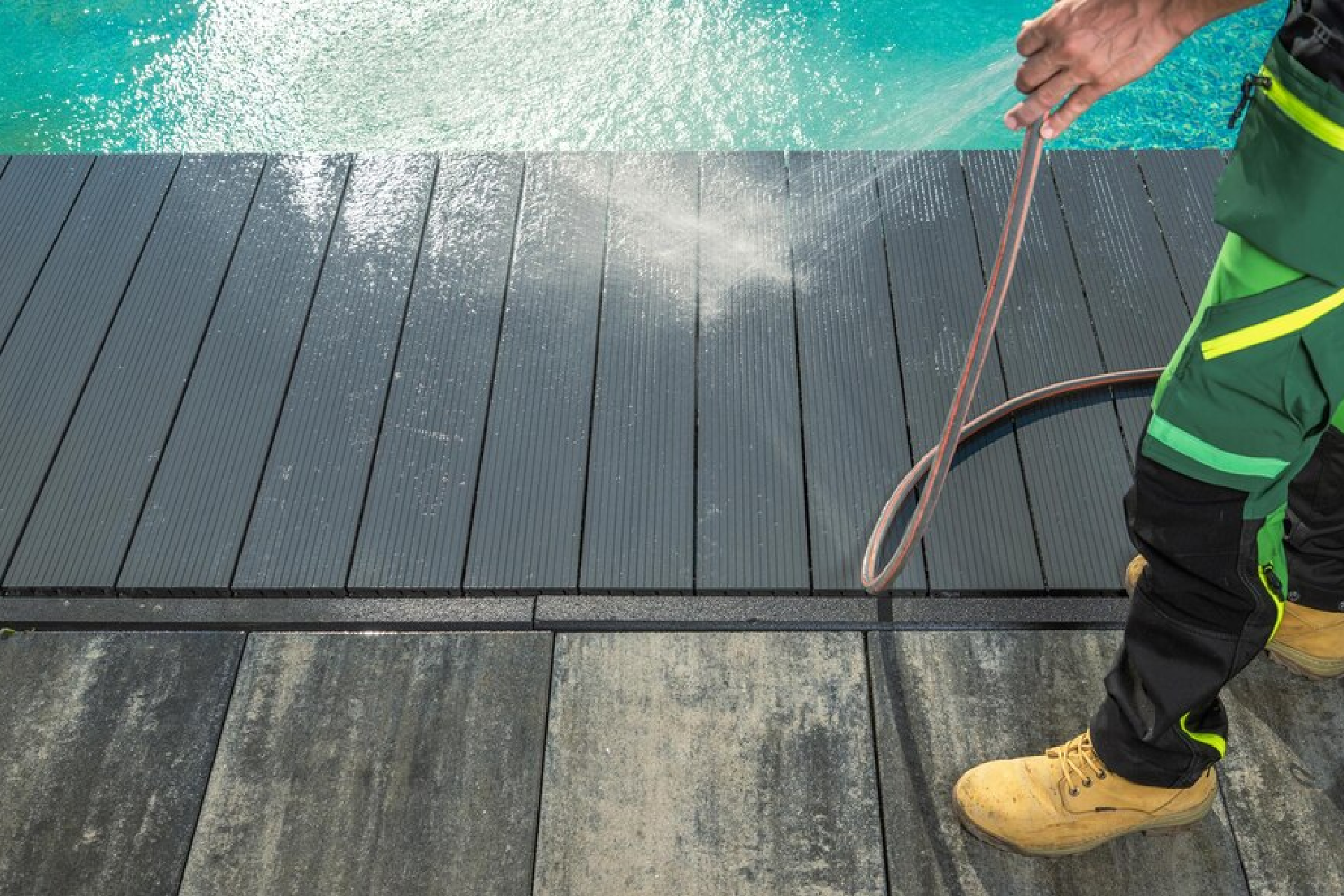 Hand of afro maintenance pool cleaner during his work. Afro hotel staff worker cleaning the pool